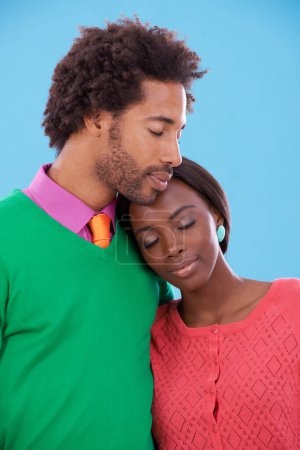 Photo for Hug, love and black couple with marriage, happy and romance on a blue studio background. Relationship, embrace and man with woman and peace with fashion and bonding together with a date and care. - Royalty Free Image