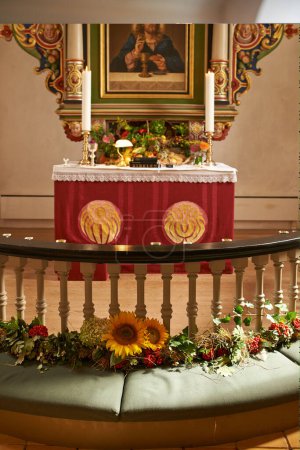 Photo for Christian, shrine or altar in church for religion, worship and spiritual space for Catholic ceremony or culture. Praise, god and painting of Jesus in chapel with candles and holy bible on table. - Royalty Free Image