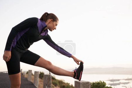 Photo for Nature, stretching and woman on road for fitness, workout and commitment to healthy body. Exercise, wellness and girl runner in muscle warm up for outdoor marathon training, performance and morning - Royalty Free Image
