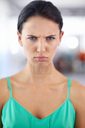 Portrait, frown and angry with woman, stress and emotions with expression and frustrated. Face, person and girl with reaction and defensive body language with bad news or rage with feedback and emoji.