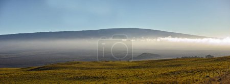Photo for Mountain, clouds and natural landscape with field, blue sky and calm banner for travel location. Nature, fog and sustainable environment with earth, peace and holiday destination with conservation. - Royalty Free Image