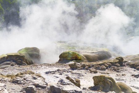 Rocks, smoke or vapor in nature with landscape, sulphuric pool or volcano in environment. Steam, mist and fog with heat from natural hot spring, Earth and stone with mountain for travel or tourism.