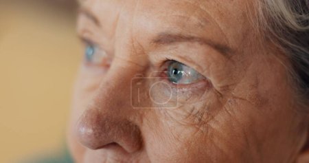 Photo for Eyes, thinking and senior woman at nursing home with fear, stress and worry or depression in closeup. Anxiety, face and elderly lady with nostalgia, doubt and dementia for memory loss or Alzheimer. - Royalty Free Image
