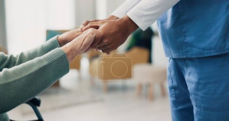 Photo for Nurse, senior patient and holding hands in closeup for support, help and recovery in retirement. Physiotherapist, care and elderly person with disability in wheelchair at clinic for rehabilitation. - Royalty Free Image