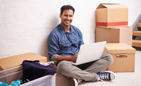 Photo for Portrait, man and laptop by boxes in new house, apartment or property for moving, relocating or buying a home. Male person, real estate and mortgage for homeowner with computer, communication or tech. - Royalty Free Image