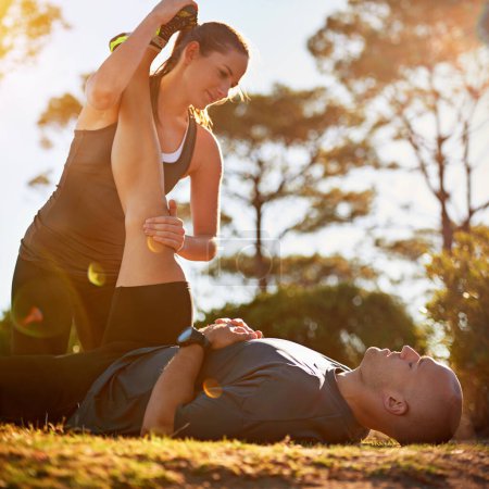 Photo for Nature, help and couple stretching for fitness, workout coach and physio for healthy body. Exercise, wellness and woman with man in muscle warm up for outdoor training in morning on forest ground - Royalty Free Image