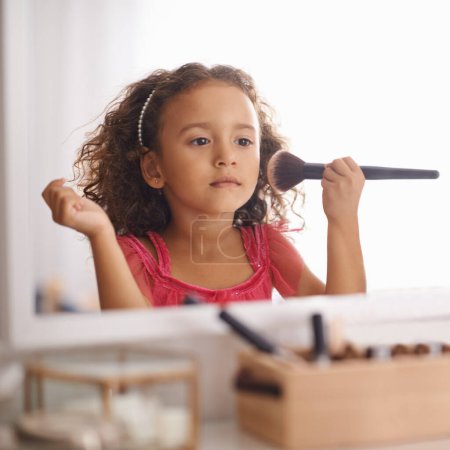 Photo for Child, girl and makeup with brush on mirror for role play for creativity and artistic. Kid, female person and bedroom with playing for development, growth and cute for childhood memories and fun - Royalty Free Image