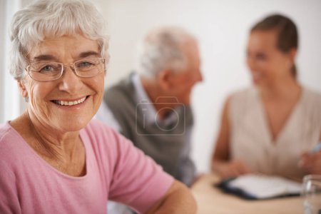 Senior, woman and happiness portrait in home with financial advisor for retirement planning or life insurance by table. Elderly, people and face with consultant for title deed and pension agreement.