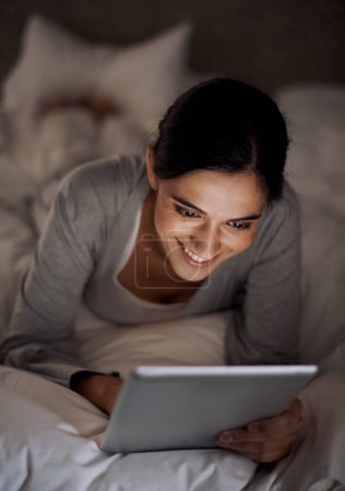 Photo for House, bedroom and woman with smile for tablet on social media, chatting and texting on site of app. Bed, female person and girl with technology for reading ebook to relax and online with internet. - Royalty Free Image