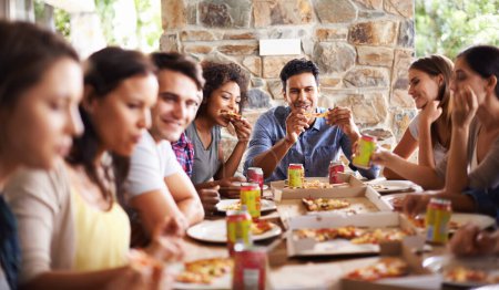 Photo for Friends, group and eating of pizza in home with happiness, soda and social gathering for bonding in dining room. Men, women and fast food with smile, drinks and diversity at table in lounge of house. - Royalty Free Image