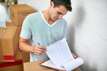 Photo for Man, boxes and home with clipboard for moving, delivery and documentation for logistics, check and invoice. Person, cardboard and package with paperwork for service, signature or stock in new house. - Royalty Free Image
