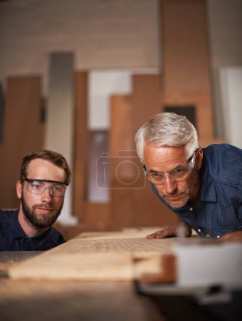Photo for Workshop, wood and father with son, teamwork and construction with property development and cooperation. Family, parent and collaboration with maintenance and planning with solution, tools and gear. - Royalty Free Image