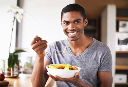 Photo for Man, fruit salad and plate in portrait for eating, detox or happy in home kitchen for breakfast. African person, smile and pride for food, nutrition or vegan diet for health, wellness or meal in bowl. - Royalty Free Image