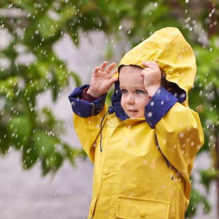 Photo for Happy, boy and rain jacket in winter with thinking for carefree, childhood and enjoyment in Germany. Kid, smile and wondering in nature for vacation, weekend or holiday travel in cold weather. - Royalty Free Image