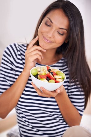 Photo for Woman, smile and fruit bowl and thinking, natural nutrition and healthy organic food. Happy, female person with snack with vitamins for skin and body wellness, balance diet or excited vegan choice. - Royalty Free Image