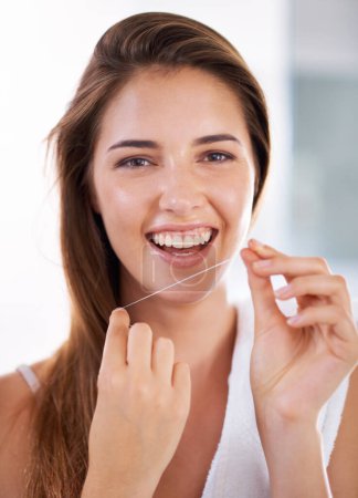 Photo for Happy, dental and portrait of woman with floss for health, wellness and clean routine for hygiene. Oral care, smile and female person with dentistry tool for teeth or mouth treatment in bathroom - Royalty Free Image