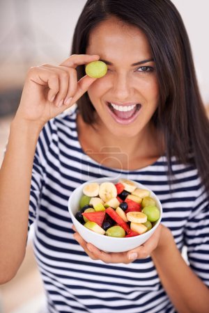 Photo for Playful, woman and fruit salad with smile, natural nutrition and healthy organic food. Happy, female person with snack with vitamins for skin and body wellness, balance diet and excited vegan choice. - Royalty Free Image