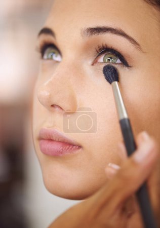 Photo for Woman, makeup and cosmetics with brush for beauty, facial treatment or eye shadow at home. Closeup of female person, face or model applying foundation, contour or glow for skincare, color or glamour. - Royalty Free Image