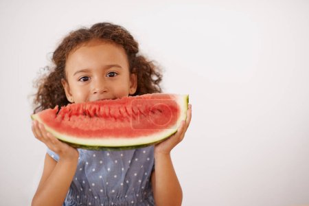Eyes, portrait or girl with watermelon in studio for healthy, diet or wellness on grey background. Fruit, mockup or kid model face with gut health, nutrition or organic snack for digestion support.