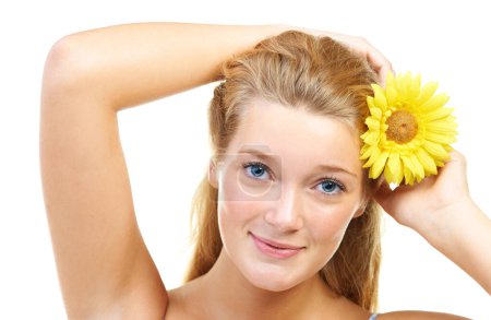 Photo for Skincare, portrait and happy woman in studio with sunflower in her hair for natural cosmetics on white background, Flower, smile or model face with wellness, glowing skin or organic beauty treatment. - Royalty Free Image