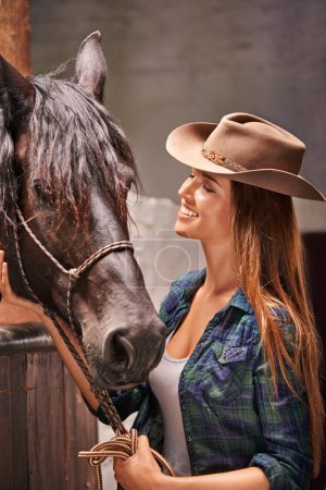 Photo for Horse, farm and smile with young woman in barn or stable for work in agriculture or sustainability. Cowgirl, texas or ranch and happy animal farmer or owner with stallion for equestrian training. - Royalty Free Image