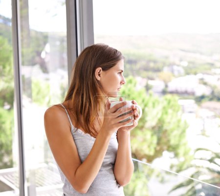 Photo for Coffee, woman and relax on balcony with view, weekend and espresso cup for morning inspiration. Young lady, thinking or peace with cocoa for comfort, mindfulness or calm on break in modern apartment. - Royalty Free Image