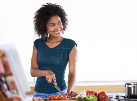 Photo for Cooking, happy woman and cutting vegetables in kitchen with recipe book for healthy diet, nutrition or mockup. Chopping board, food and African person thinking of dinner or organic meal prep in home. - Royalty Free Image