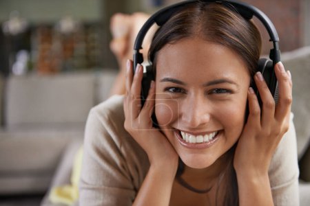 Photo for Music, listening and portrait of happy woman on sofa in home streaming radio, playlist or podcast. Girl, smile and hearing sound from headphones on couch with free audio or relax with rock song. - Royalty Free Image