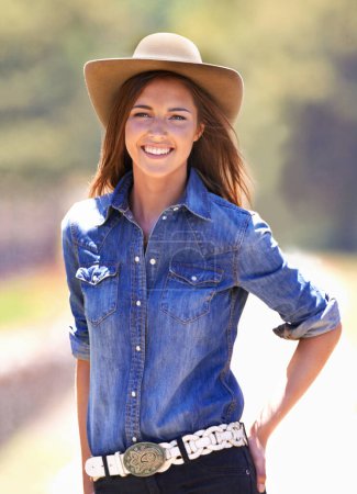 Photo for Happy woman, portrait and cowgirl with hat on farm for adventure, travel or outdoor journey in Texas. Female person with smile in western fashion, denim shirt and cap at ranch in the countryside. - Royalty Free Image
