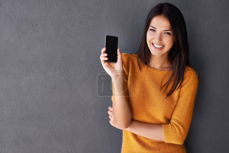 Photo for Phone screen, portrait or woman with mockup for contact, web or communication on wall background. Smartphone, space or face of lady person happy for google it, search or Netflix and chill sign up app. - Royalty Free Image