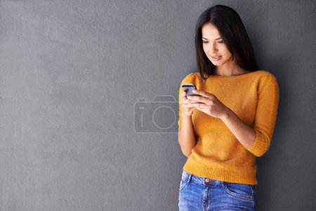 Photo for Phone, search and woman in house with social media, scroll or reading sign up info on wall background. Smartphone, app and female person at home online with google it, competition or giveaway sign up. - Royalty Free Image