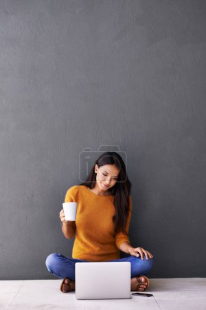 Photo for Laptop, search and woman on floor with coffee while streaming, reading or watching movie on wall background. Computer, mockup or female person online for google it, menu or Netflix and chill sign up. - Royalty Free Image