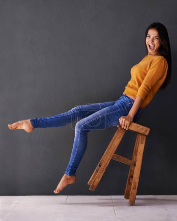 Photo for Woman, smile and portrait on chair for clothes, trend and style for fashion and bold color for weekend. Female person, model and happy with jersey for casual outfit, stylish and fashionable on mockup. - Royalty Free Image