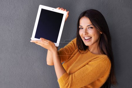 Photo for Woman, portrait and tablet screen in studio, display and mockup space for website or app. Happy female person, online and blank or empty for marketing or advertising, social media and gray background. - Royalty Free Image