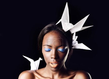 Photo for Black woman, eyeshadow and fine art with beauty, dove or origami birds on a dark studio background. Closeup or face of African female person or model with blue makeup or cosmetics on mockup space. - Royalty Free Image