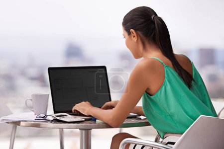 Photo for Woman, outdoor and laptop screen for planning, research and copywriting on her balcony. business writer, editor or freelancer back, typing on computer for editing on website in work from home project. - Royalty Free Image