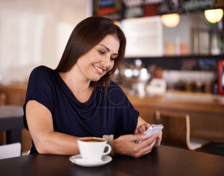 Photo for Happy woman, cafe and typing with phone for communication, social media or networking at coffee shop. Female person with smile on mobile smartphone for online chatting or texting at indoor restaurant. - Royalty Free Image