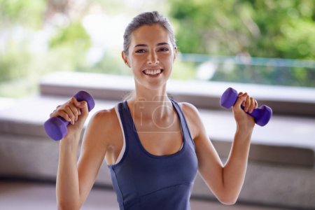 Photo for Portrait, smile and sporty woman weight lifting at gym for health, wellness or workout. Exercise, dumbbells for training and happy young person satisfied with performance, progress or wellbeing. - Royalty Free Image