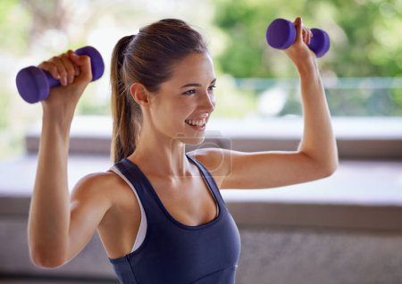 Photo for Happy woman, strong and dumbbells for fitness, wellness and training for workout indoors in house, home and apartment. Female person, sport or athlete with weights for exercise, health and cardio. - Royalty Free Image