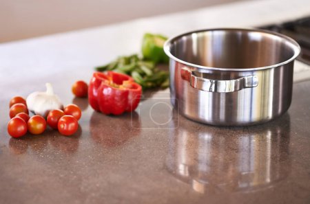 Photo for Kitchen counter, pot and vegetable ingredients to cook for healthy, meal and supper for wellbeing, diet and nutrition. Home, natural and fresh with organic food to prepare for dinner and soup. - Royalty Free Image