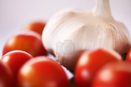 Home, garlic and tomatoes with kitchen counter, ingredients and groceries with recipe and healthy. Wellness, closeup and mockup space with vegetables and nutrition with vegan and organic food.