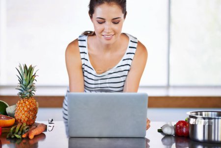 Photo for Woman, thinking and laptop on kitchen counter, happy female person and home on internet. Google it, browsing cooking recipes and social media, online search on technology for healthy food ideas. - Royalty Free Image