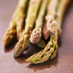 Vegetable, healthy and asparagus for cooking, food and nutrition at home, house and kitchen with macro on table. Sparrow grass, edible plants and fresh produce for vegan dish, clean eating and diet.