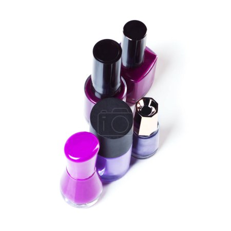 Photo for Nail polish, color and purple paint on a white background for beauty, cosmetics and salon products. Cosmetology, luxury spa and isolated bottles for nails manicure, pedicure and pamper in studio. - Royalty Free Image