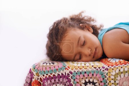 Photo for Child, sleeping and relax on bed in home, dreaming and wellness on quilt blanket for childhood development. Girl, tired or rest in bedroom on summer vacation, peace or comfort for cozy break in house. - Royalty Free Image