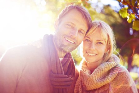 Photo for Portrait, hug and sunshine with couple in a park, nature and love with marriage and happiness. Face, embrace or man with woman or lens flare with vacation for anniversary or summer with weekend break. - Royalty Free Image