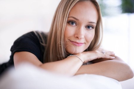 Photo for Face, woman and smile for confidence in living room or home for leisure, break and enjoy in couch. Housewife, happy and satisfied with comfort or joy in lounge, sofa and positivity in Sweden. - Royalty Free Image