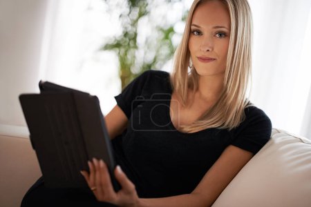 Photo for Tablet, remote work and portrait of business woman on sofa for social media, search or communication at home. Freelance, app or writer in living room for digital article research, planning or report. - Royalty Free Image