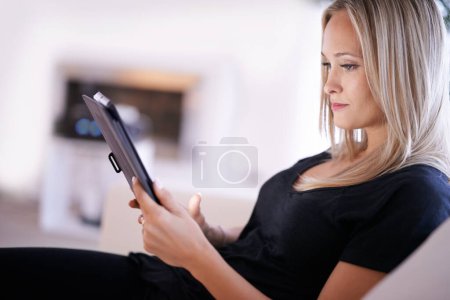 Photo for Tablet, search and woman on sofa with internet, scroll or social media, ebook or streaming at home. Digital, app or female person in a living room online with google it, sign up or netflix and chill. - Royalty Free Image