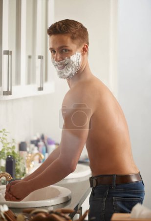 Photo for Man, foam for shaving and grooming in portrait, skincare and beauty with morning routine in bathroom. Skin health, cosmetic cream or soap for hygiene, dermatology and smile at home for hair removal. - Royalty Free Image